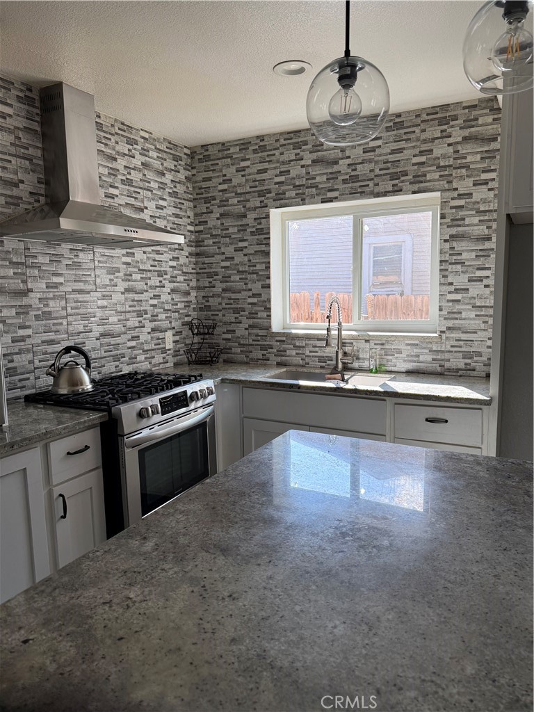 242 East M Street Colton, CA 92324 - Photo 14 of 19 a kitchen with stainless steel appliances granite countertop a sink stove and cabinets