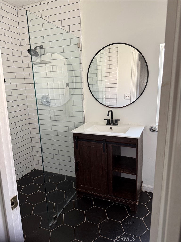242 East M Street Colton, CA 92324 - Photo 17 of 19 a bathroom with a sink a toilet and a mirror