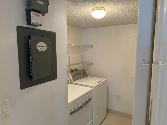 a bathroom with a granite countertop toilet sink and mirror