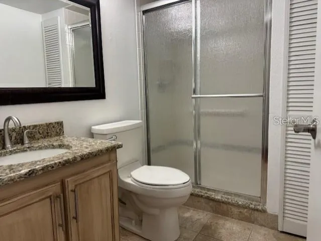 an empty room with wooden floor ceiling fan and windows