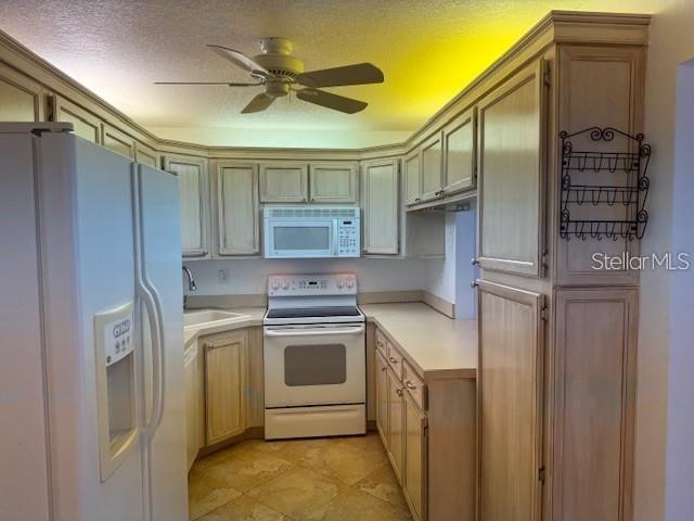 1261 Pine Ridge Circle West, Unit E2 Tarpon Springs, FL 34688 - Photo 16 of 16 a kitchen with stainless steel appliances granite countertop a refrigerator and a stove