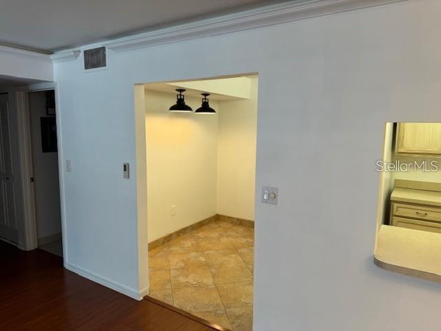 1261 Pine Ridge Circle West, Unit E2 Tarpon Springs, FL 34688 - Photo 8 of 16 wooden floor in an empty room