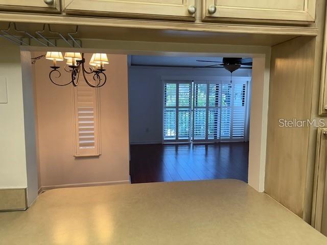 1261 Pine Ridge Circle West, Unit E2 Tarpon Springs, FL 34688 - Photo 9 of 16 a view of empty room with wooden floor and fan