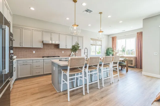 a kitchen with cabinets appliances a sink and a counter top space