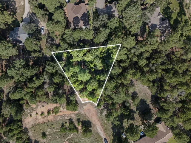 a backyard of a house with a yard with plants and flowers