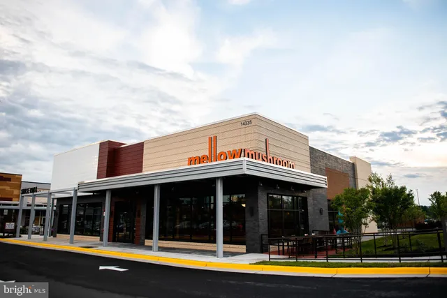 a view of a large building with a big yard and plants