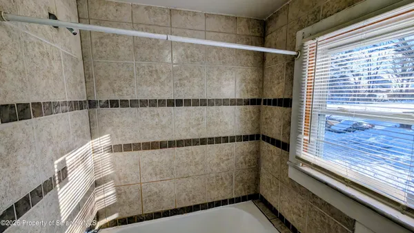 a bathroom with white walls and window