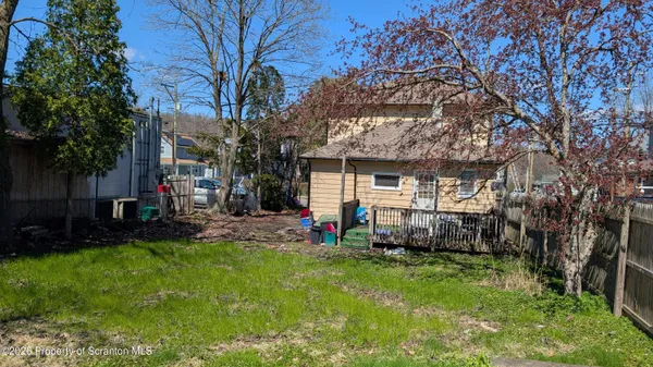 a view of house with backyard