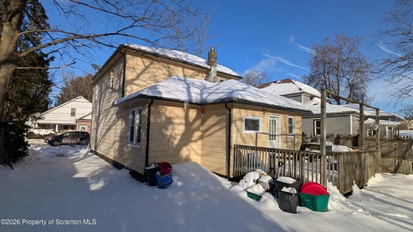 a kitchen with a large window appliances and cabinets