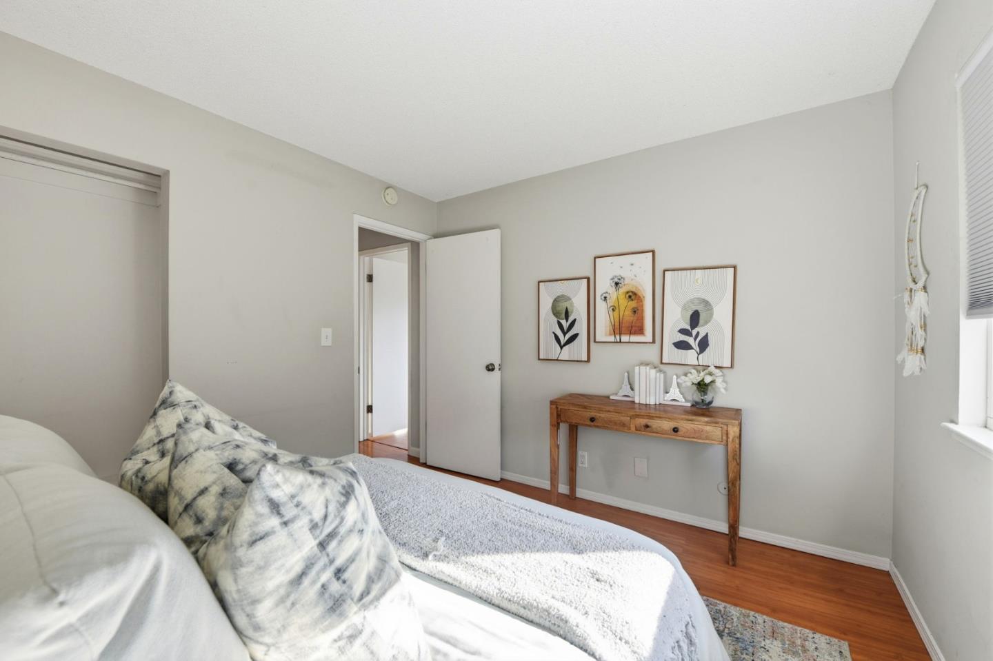 5701 Calmor Avenue, Unit 2 San Jose, CA 95123 - Photo 8 of 10 a bedroom with a bed and wooden floor