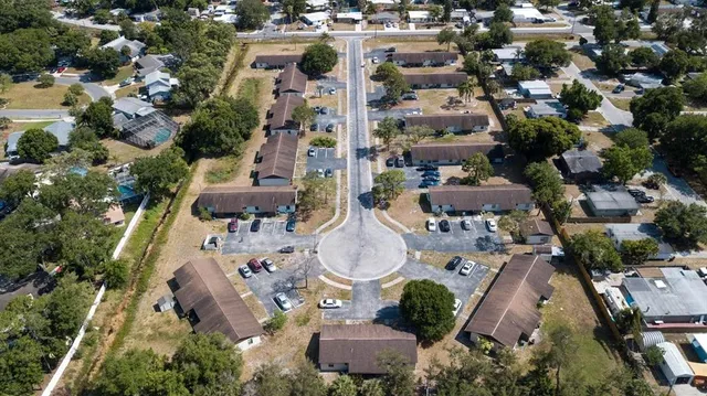 an aerial view of residential houses with outdoor space