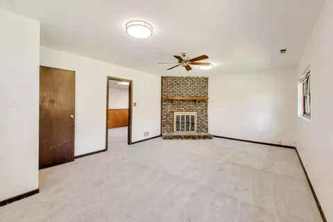 an empty room with closet and natural light