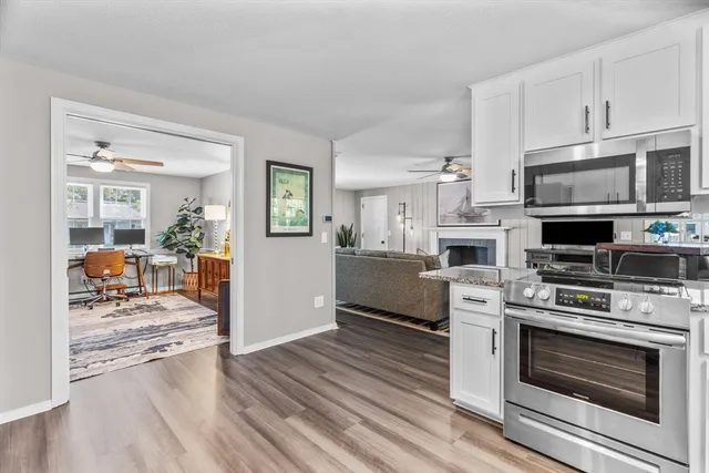 a kitchen with stainless steel appliances a stove a sink and a refrigerator