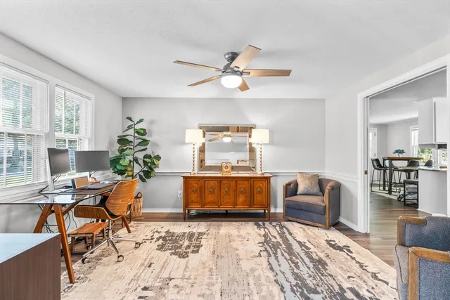 a living room with furniture and wooden floor
