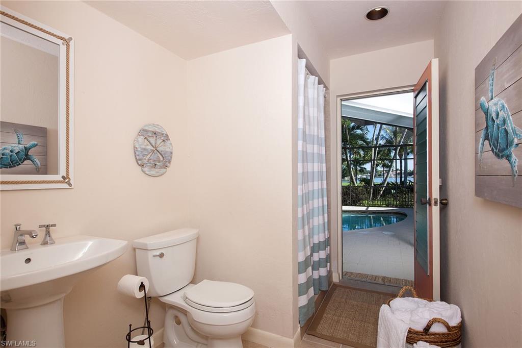 12 Sabre Lane Naples, FL 34102 - Photo 13 of 17 a bathroom with a toilet sink and shower