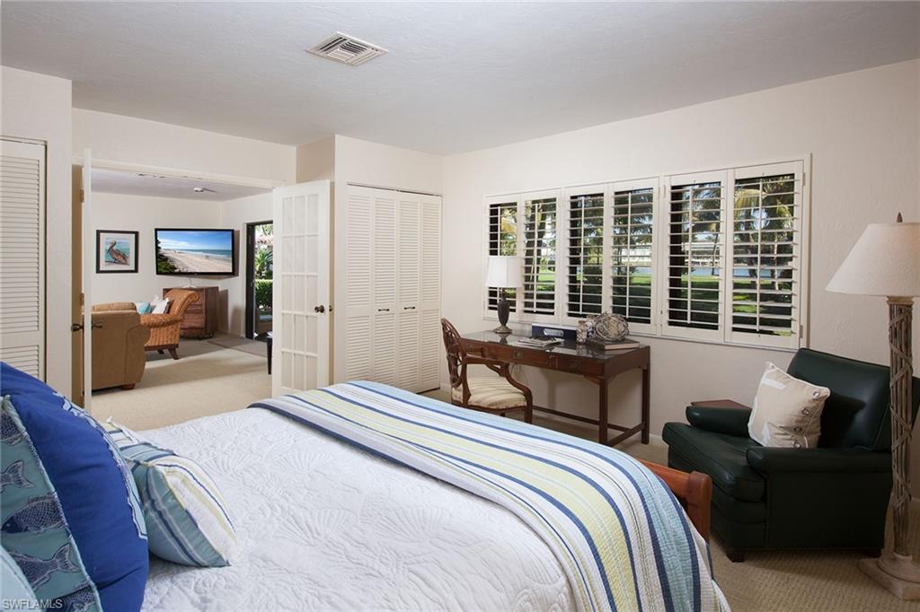 12 Sabre Lane Naples, FL 34102 - Photo 14 of 17 a bedroom with a bed and a large window