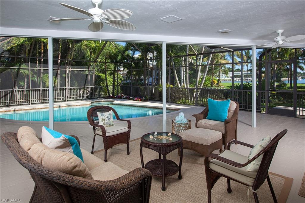 12 Sabre Lane Naples, FL 34102 - Photo 15 of 17 a living room with furniture and a large window