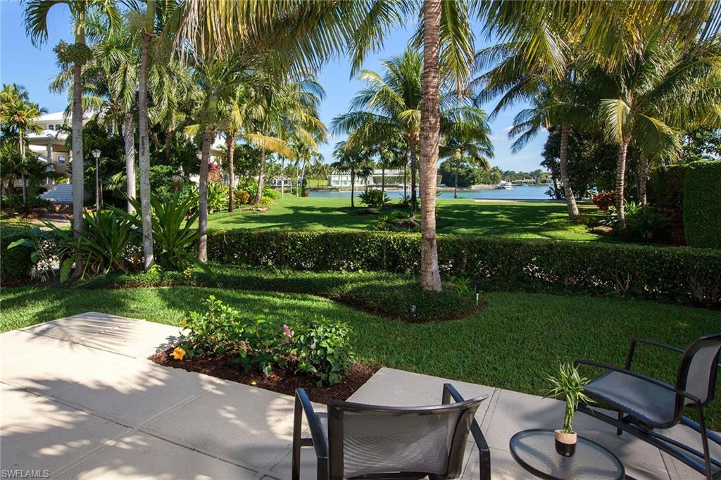 12 Sabre Lane Naples, FL 34102 - Photo 16 of 17 a view of a table and chairs in patio with a garden