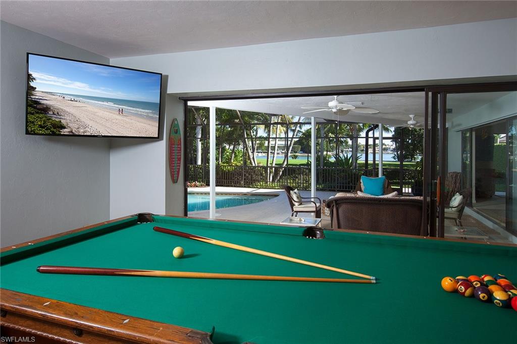 12 Sabre Lane Naples, FL 34102 - Photo 5 of 17 a room with pool table and windows