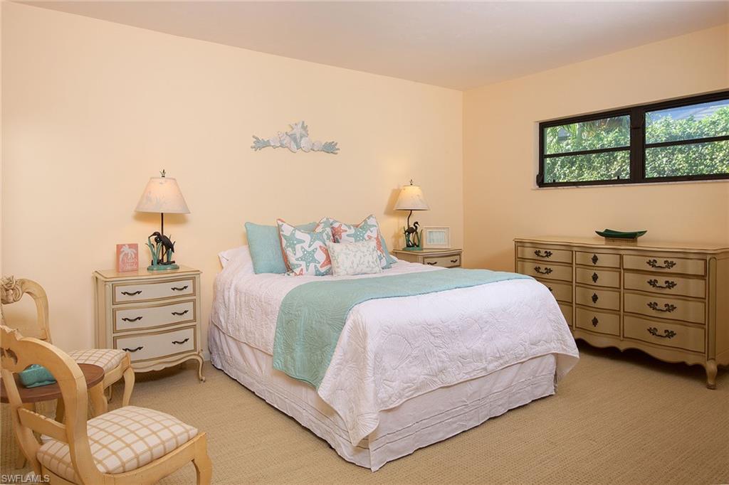 12 Sabre Lane Naples, FL 34102 - Photo 9 of 17 a bedroom with a bed and a dresser
