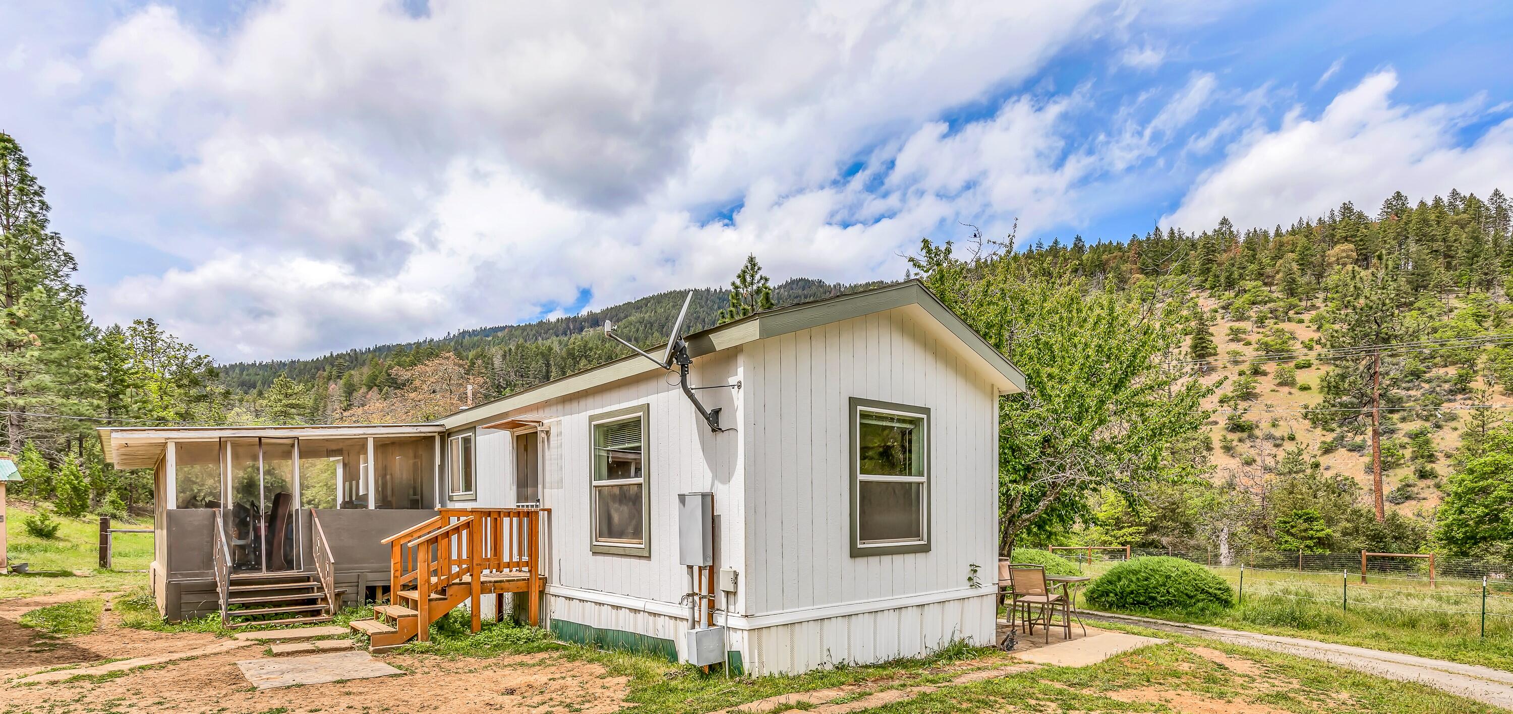13721 Upper Applegate Road Jacksonville, OR 97530 - Photo 21 of 26 a view of a wooden house with a sink and a yard