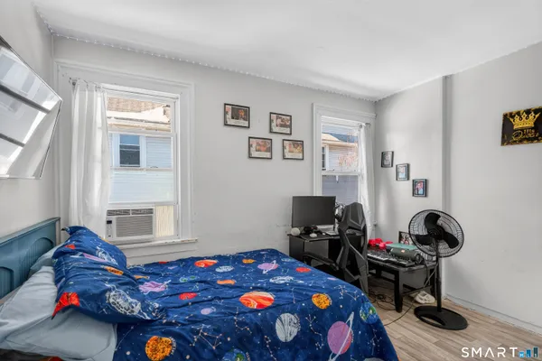 a bedroom with a bed and a window