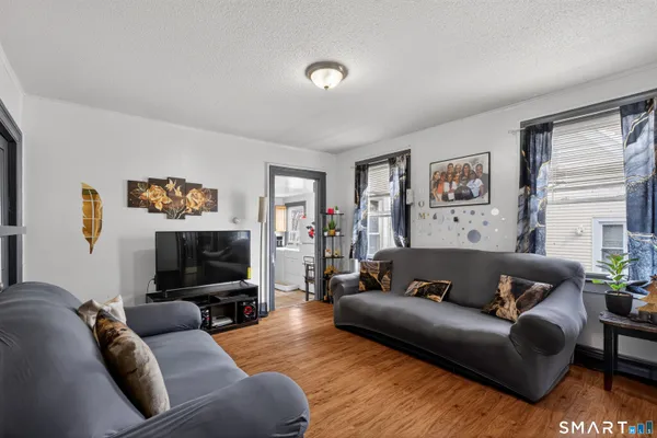a living room with furniture and a flat screen tv