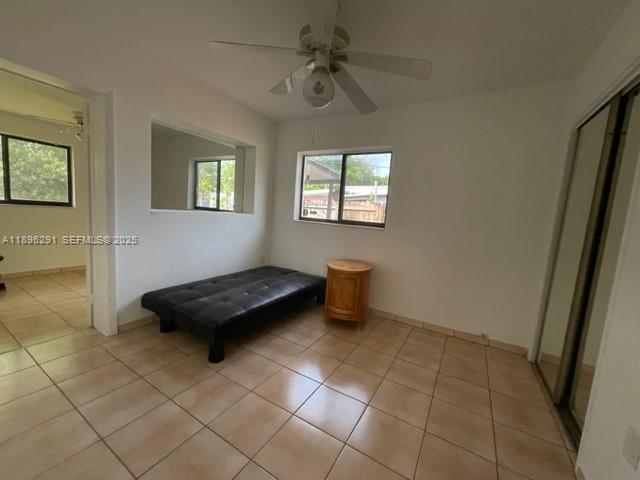 6141 Wiley Street Hollywood, FL 33023 - Photo 22 of 27 a living room with a baby crib and a table