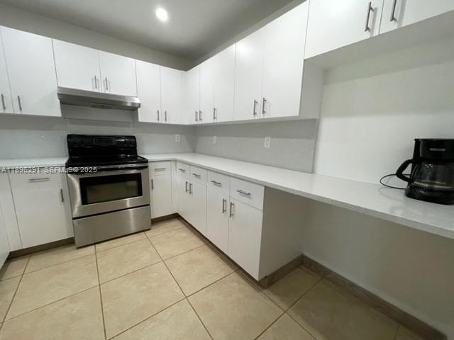 6141 Wiley Street Hollywood, FL 33023 - Photo 23 of 27 a kitchen with cabinets and appliances