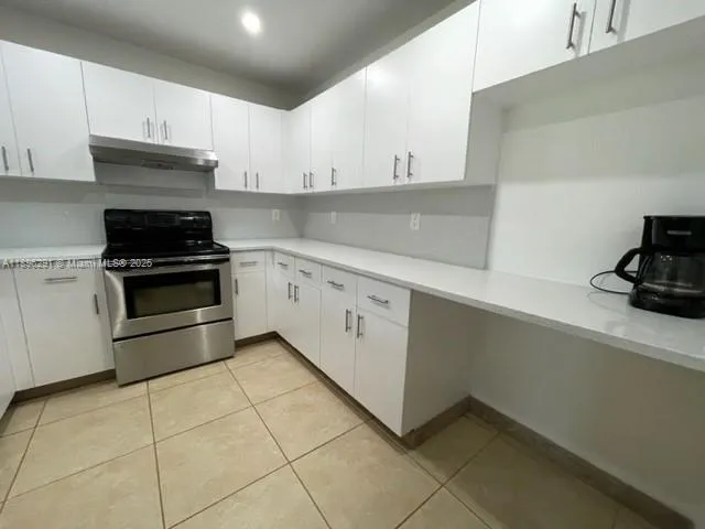 a kitchen with cabinets and appliances