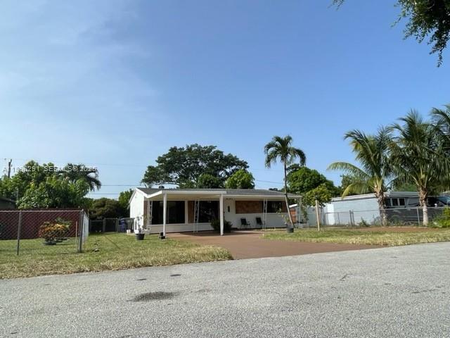 6141 Wiley Street Hollywood, FL 33023 - Photo 27 of 27 a front view of a house with a yard and garage
