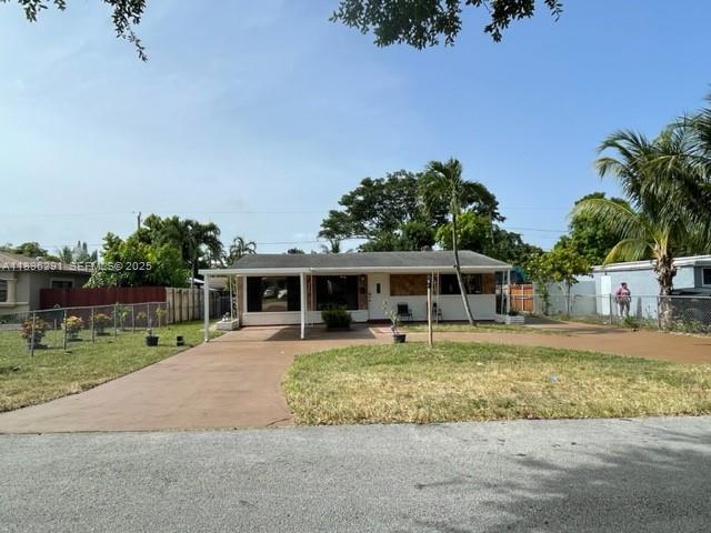 6141 Wiley Street Hollywood, FL 33023 - Photo 3 of 27 a front view of a house with garden