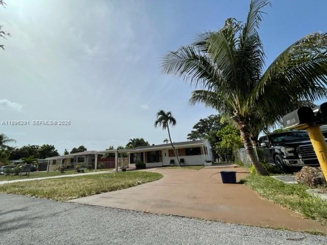 6141 Wiley Street Hollywood, FL 33023 - Photo 6 of 27 a front view of a house with a yard