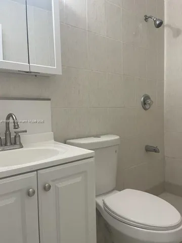 a bathroom with a sink a toilet and vanity
