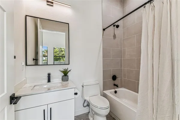 a kitchen with stainless steel appliances granite countertop a refrigerator a sink dishwasher and a stove with wooden floor