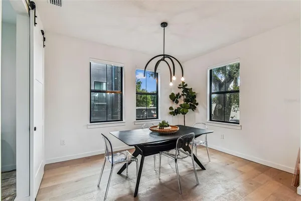 a bedroom with a bed and painting on the wall