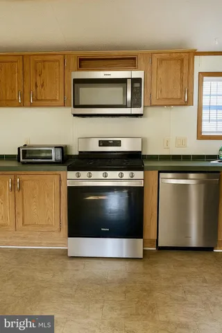 a kitchen with a stove and a microwave