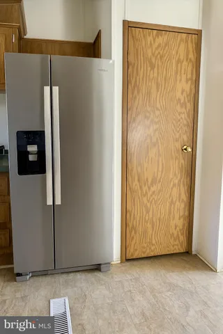 a view of a refrigerator in kitchen