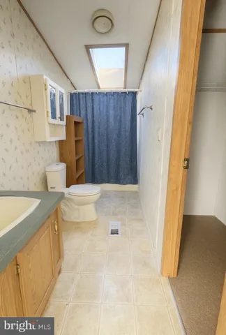a bathroom with a tub shower and sink