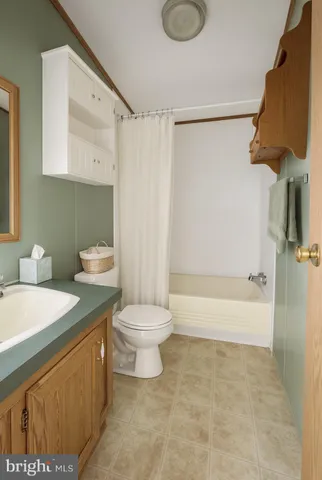 a bathroom with a sink a toilet and bathtub