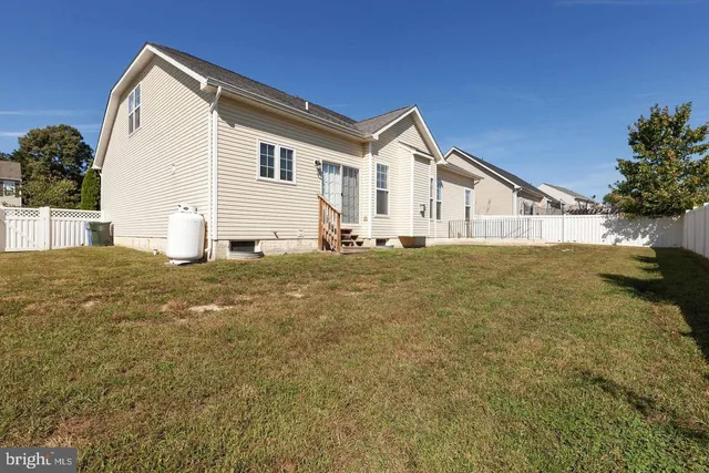 a big house with a big yard and large trees