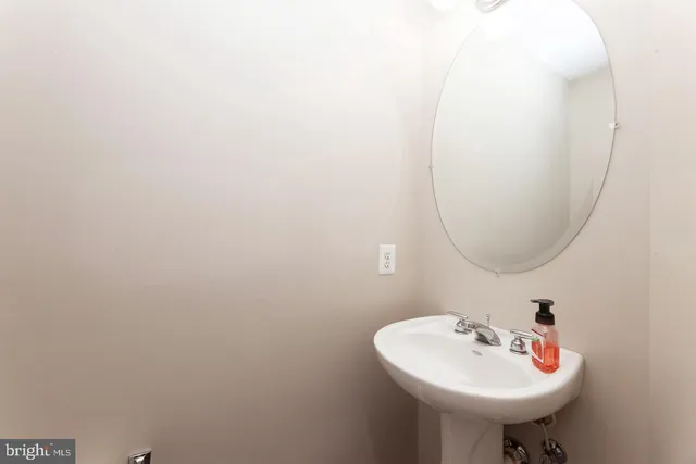 a bathroom with a sink a mirror and a toilet