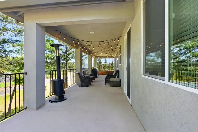 a view of a livingroom with furniture and floor to ceiling window
