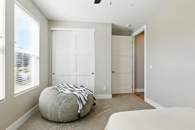 a spacious bedroom with a bed and a window