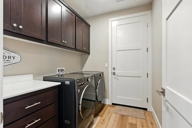 a utility room with sink dryer and washer