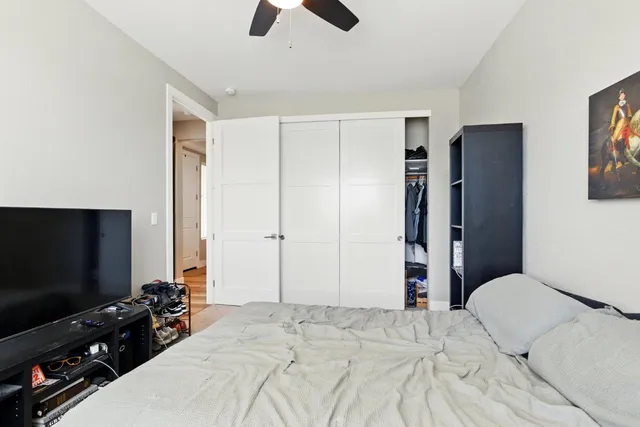 a bedroom with a bed and a flat screen tv