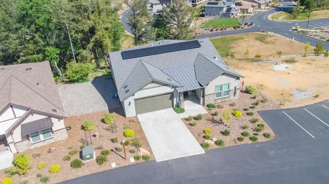 an aerial view of a house with a swimming pool