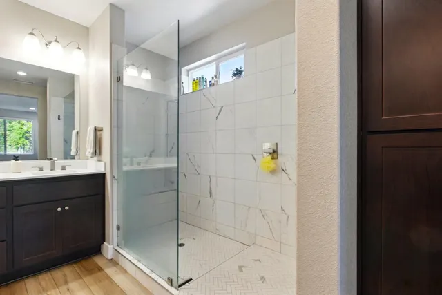 a bathroom with a shower and a sink