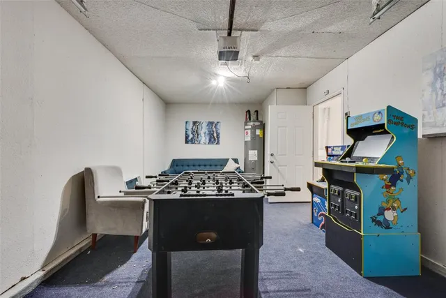 a kitchen with stainless steel appliances granite countertop a table chairs and a refrigerator