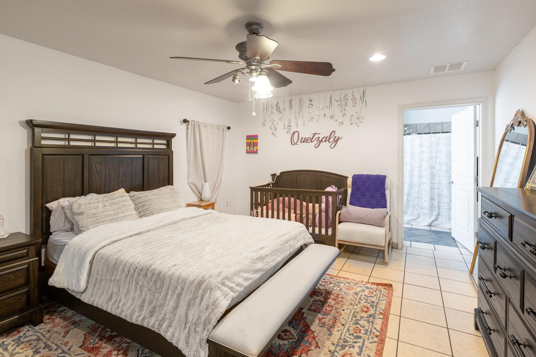176 Old Lexington Road, Unit C Elgin, TX 78621 - Photo 15 of 31 a bedroom with a bed and a chandelier